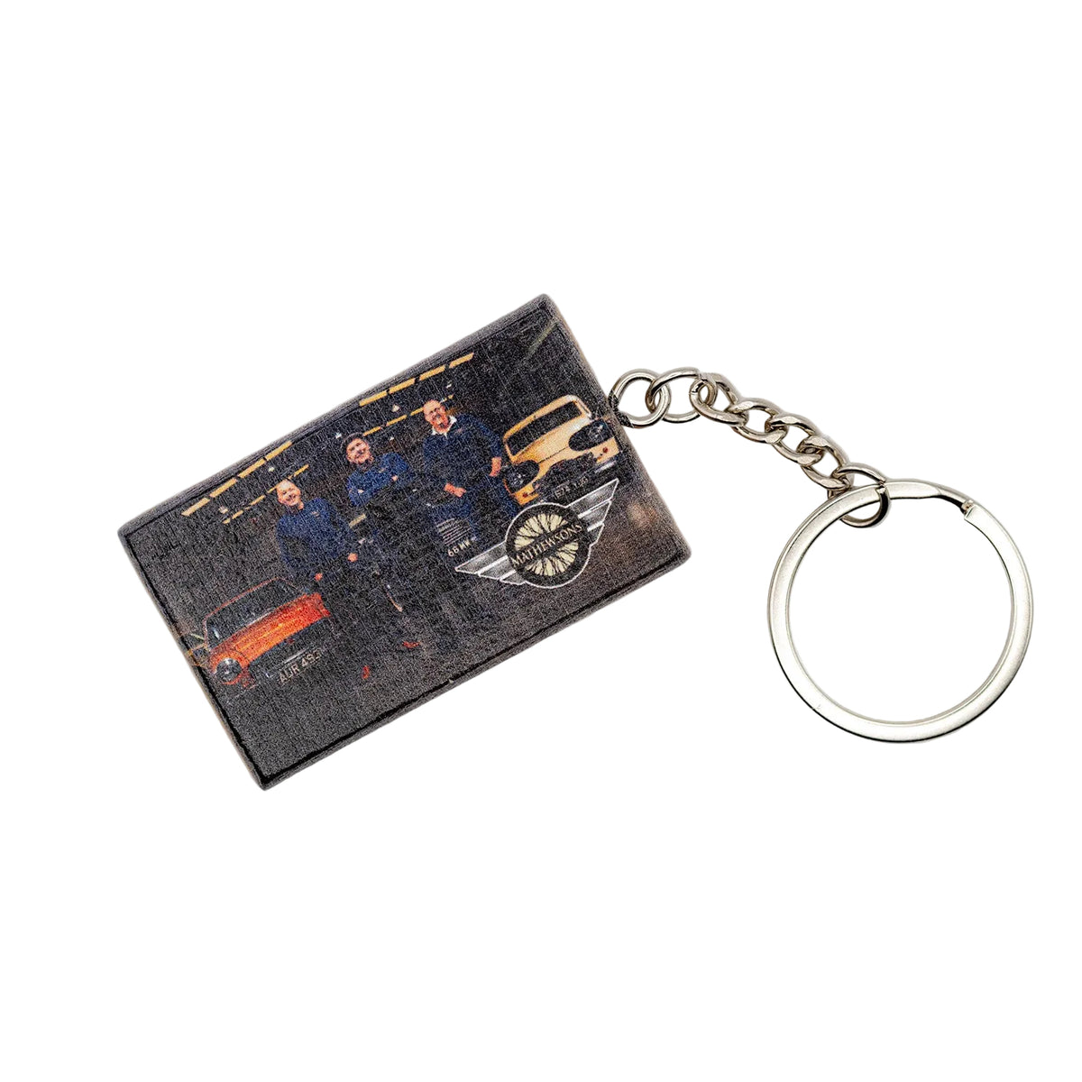Keychain with a printed card featuring people and vehicles on a white background
